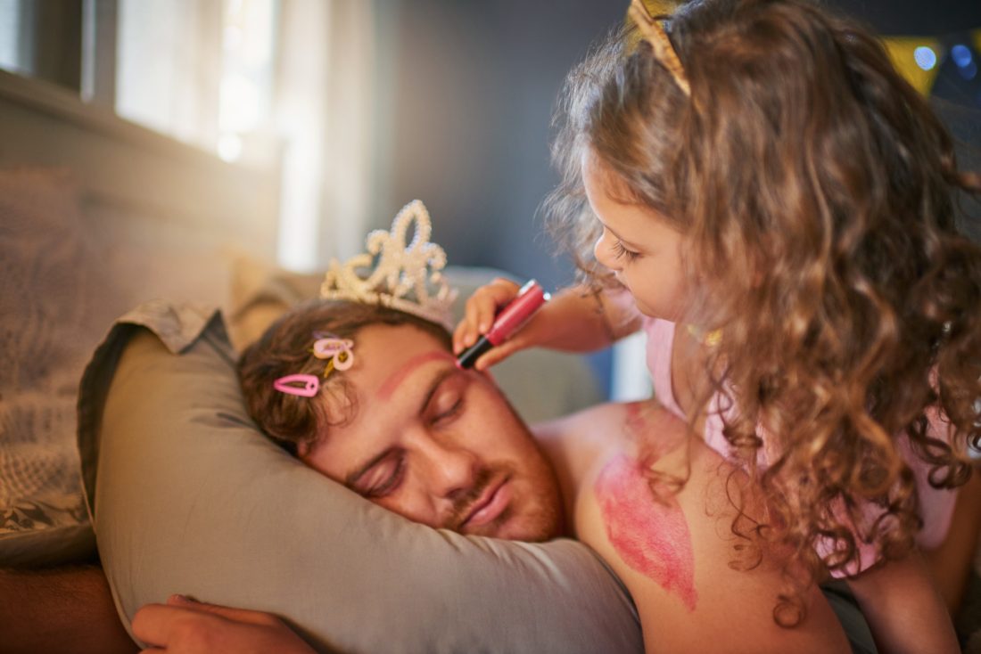 Child playing dress-up with dad